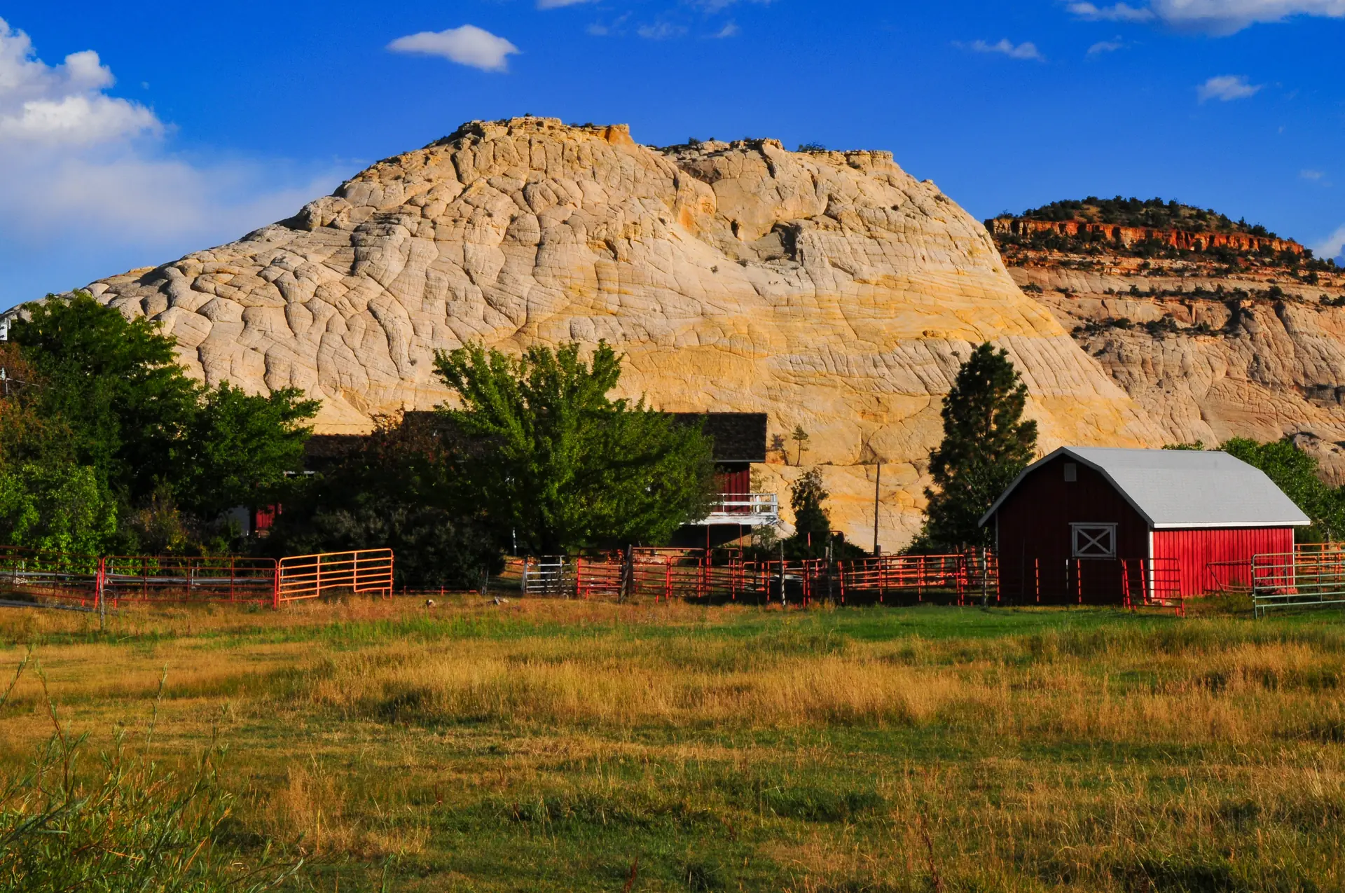 A farm and white slickrock domes at the start of the Burr Trail, Boulder, Utah